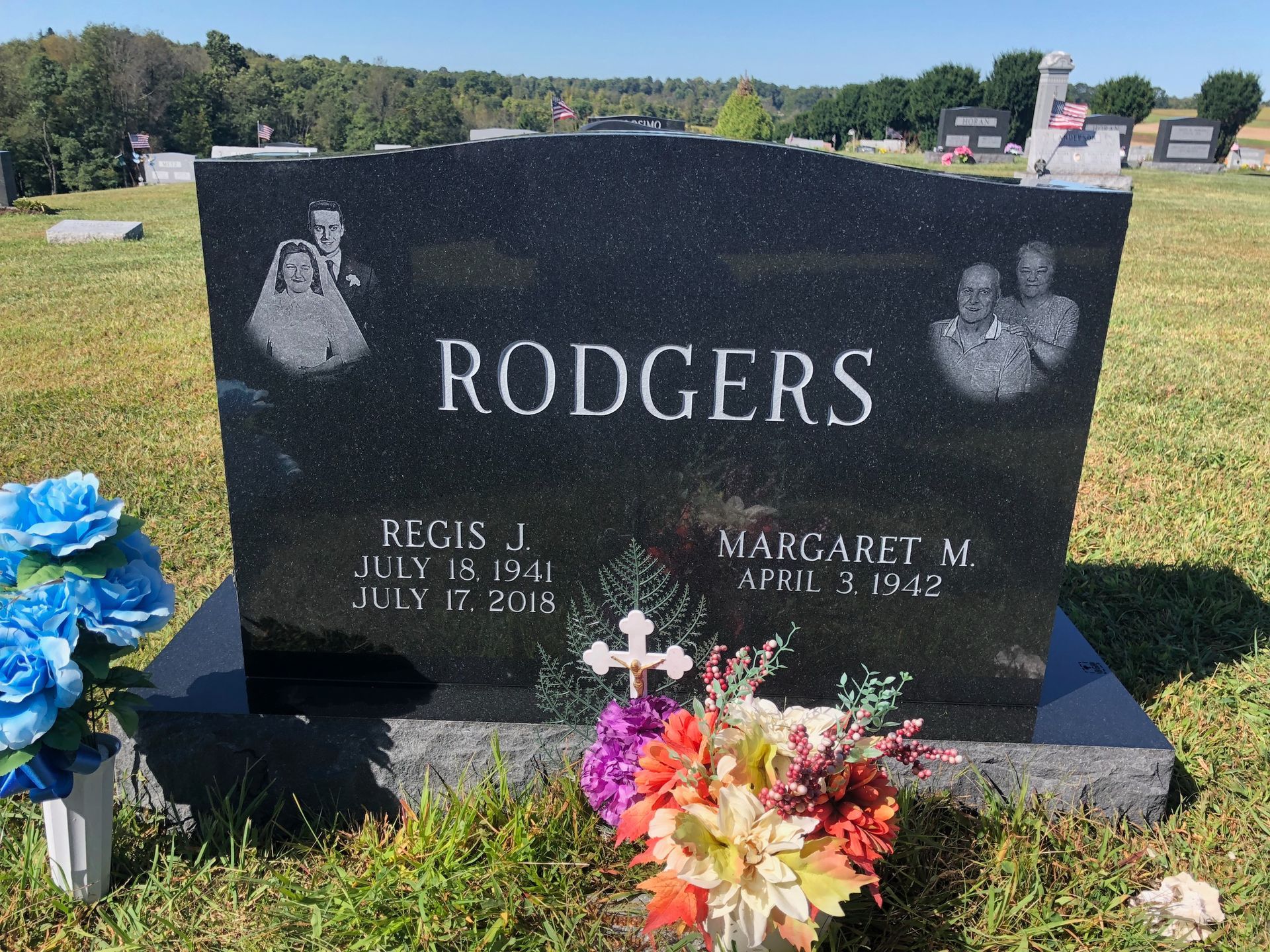Rodgers family gravestone with flowers in a sunny cemetery
