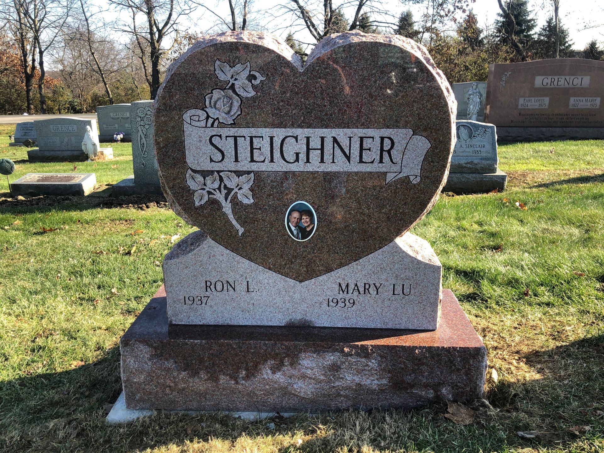 Steichner family gravestone in a cemetery, with trees and other headstones in the background.