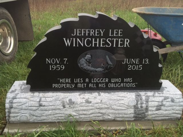 Black tombstone for Jeffrey Lee Winchester with dates Nov. 7, 1959 and June 13, 2015, on a white base
