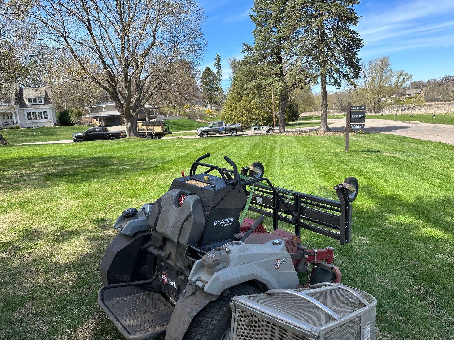 A lawn mower is parked in the middle of a lush green field.