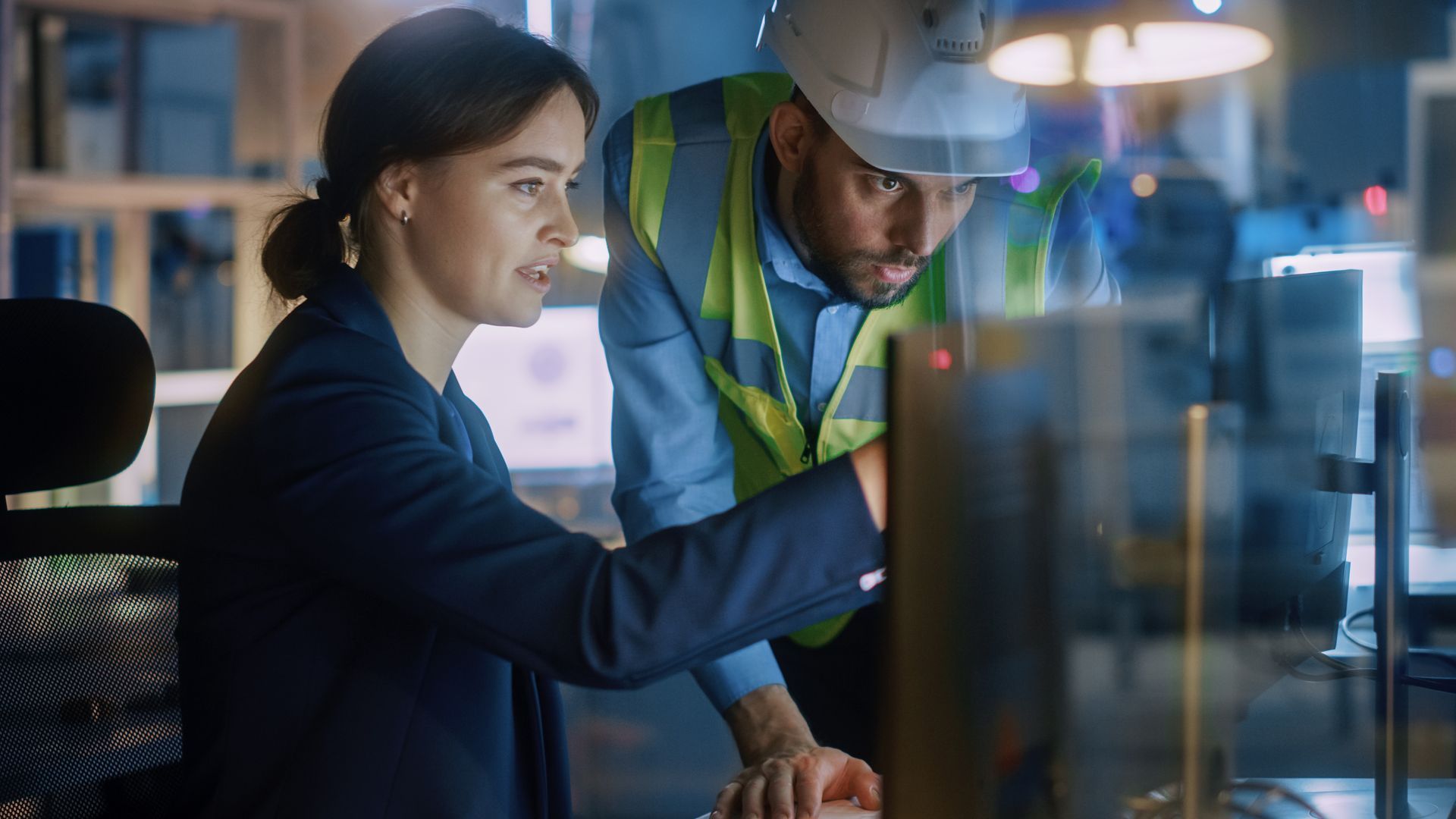 A yellow hard hat is sitting on top of a blueprint.
