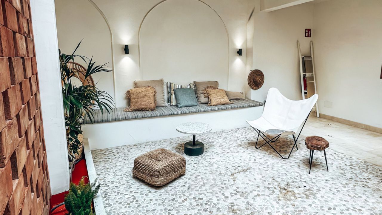 A living room with a couch , chair , table and rug.