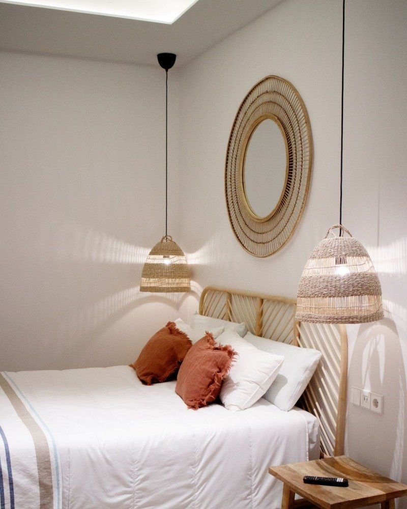 A bedroom with a bed and a mirror on the wall