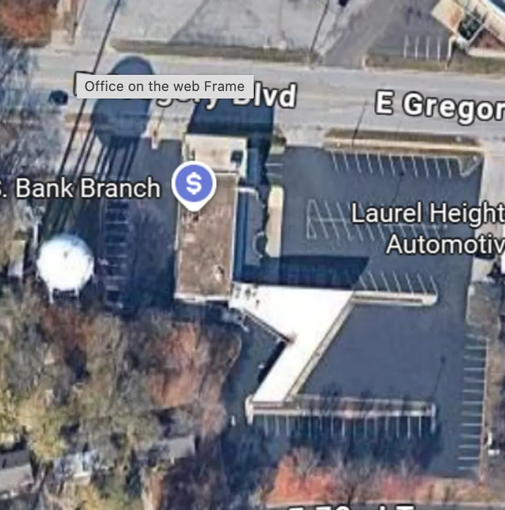 Aerial view of a U.S. Bank branch next to Laurel Heights Automotive on a city street.