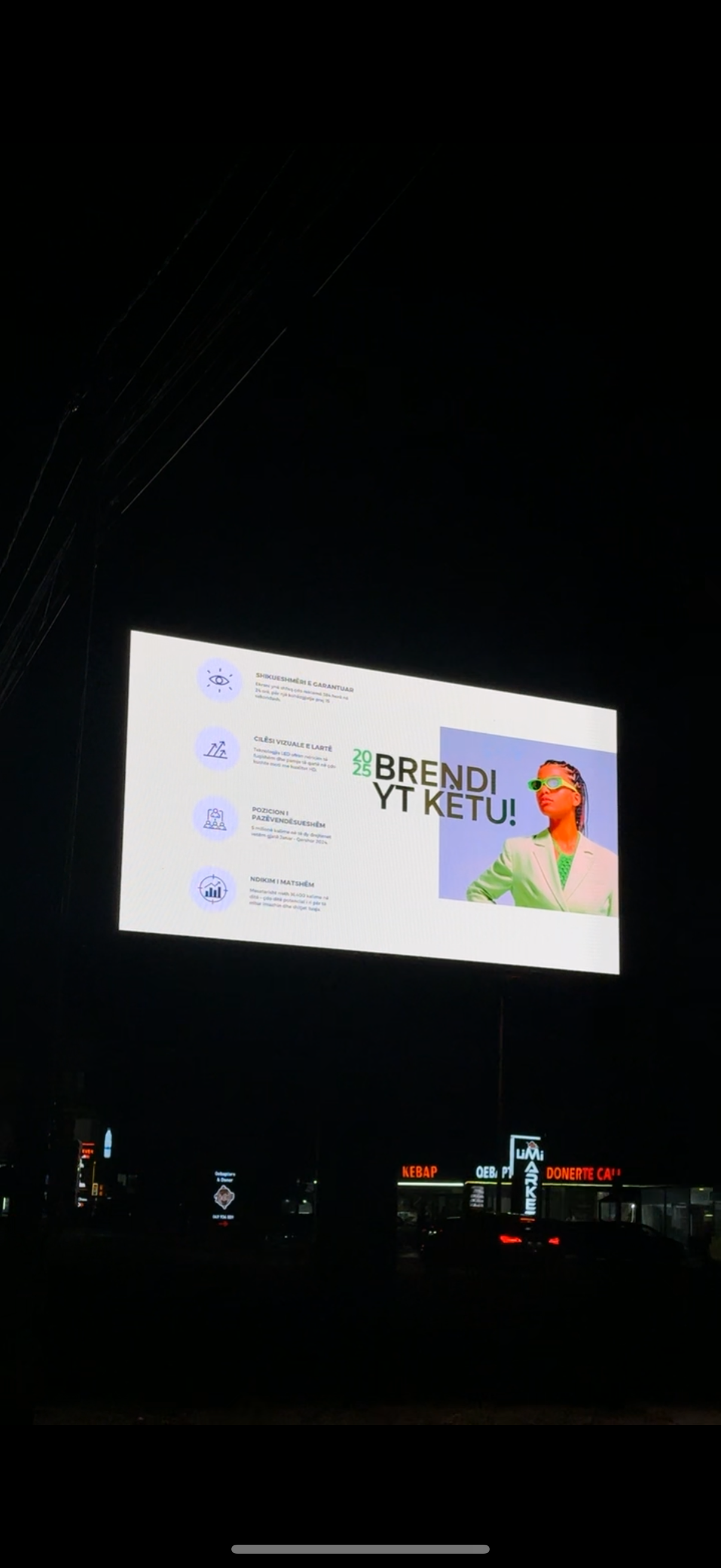 Billboard at night with text and a portrait of the Youtuber BENDI YT KETUL.