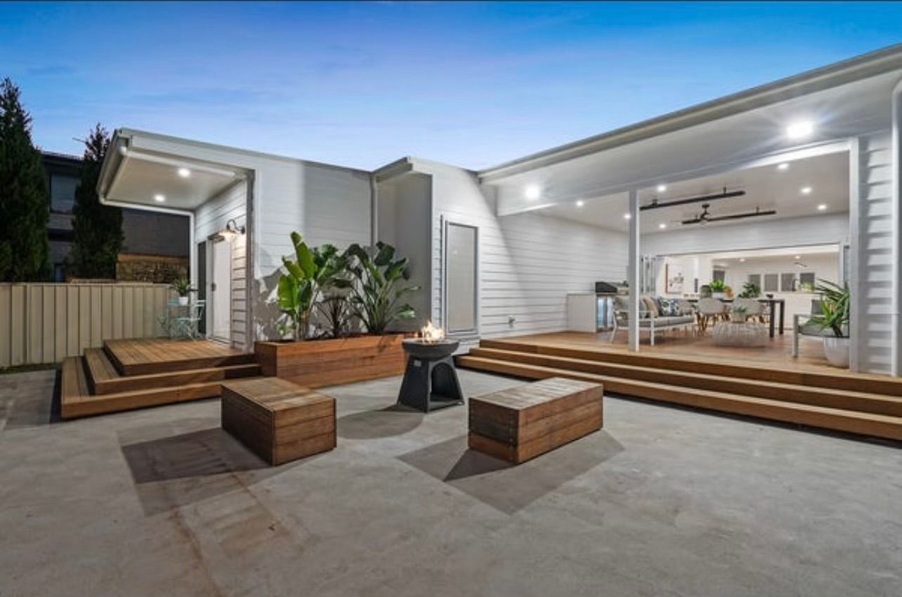 Freshly oiled hardwood deck overlooking a backyard garden