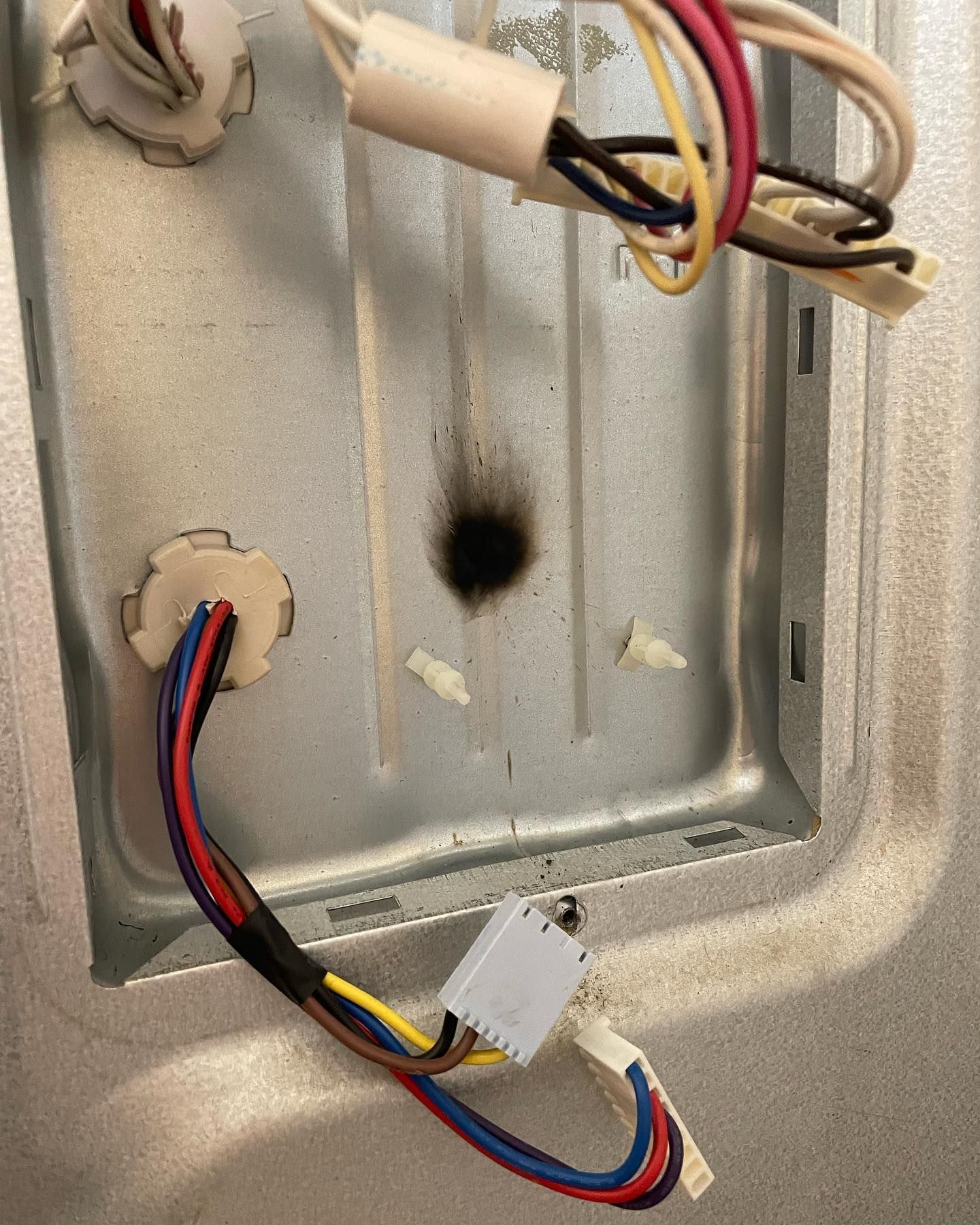 A bunch of wires are connected to a metal surface.
