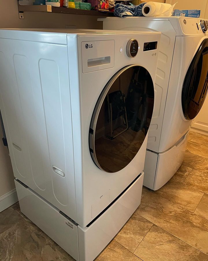 A washer and dryer are sitting next to each other in a laundry room.
