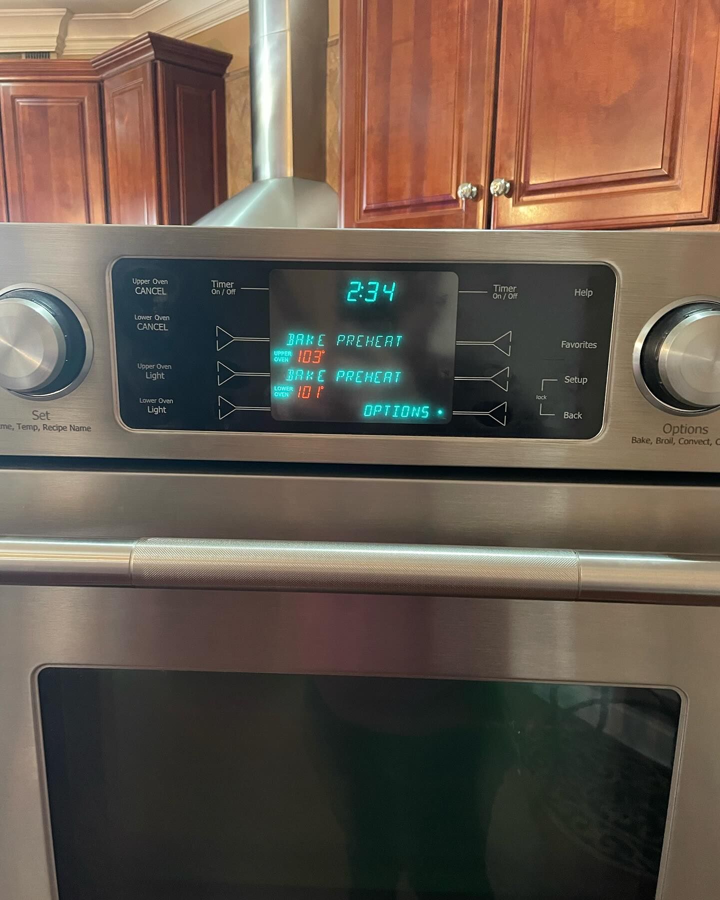 A stainless steel oven with a digital display that says 23 v