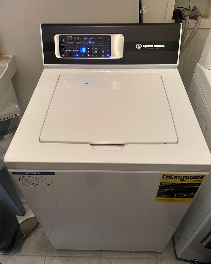 A white washer and dryer with the lid open