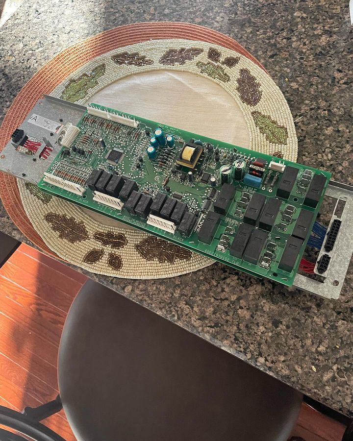 A motherboard is sitting on top of a plate on a counter.