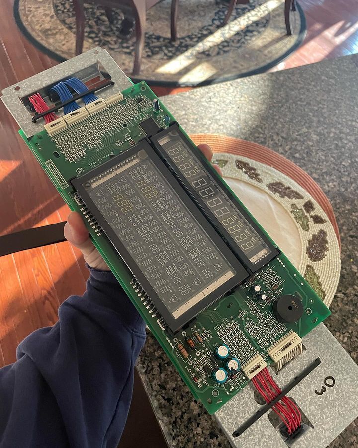 A person is holding a piece of electronic equipment in their hand.