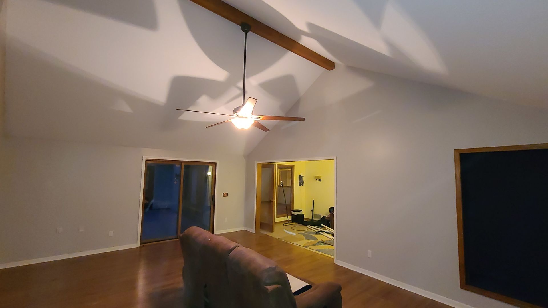 A living room with a ceiling fan and a couch.