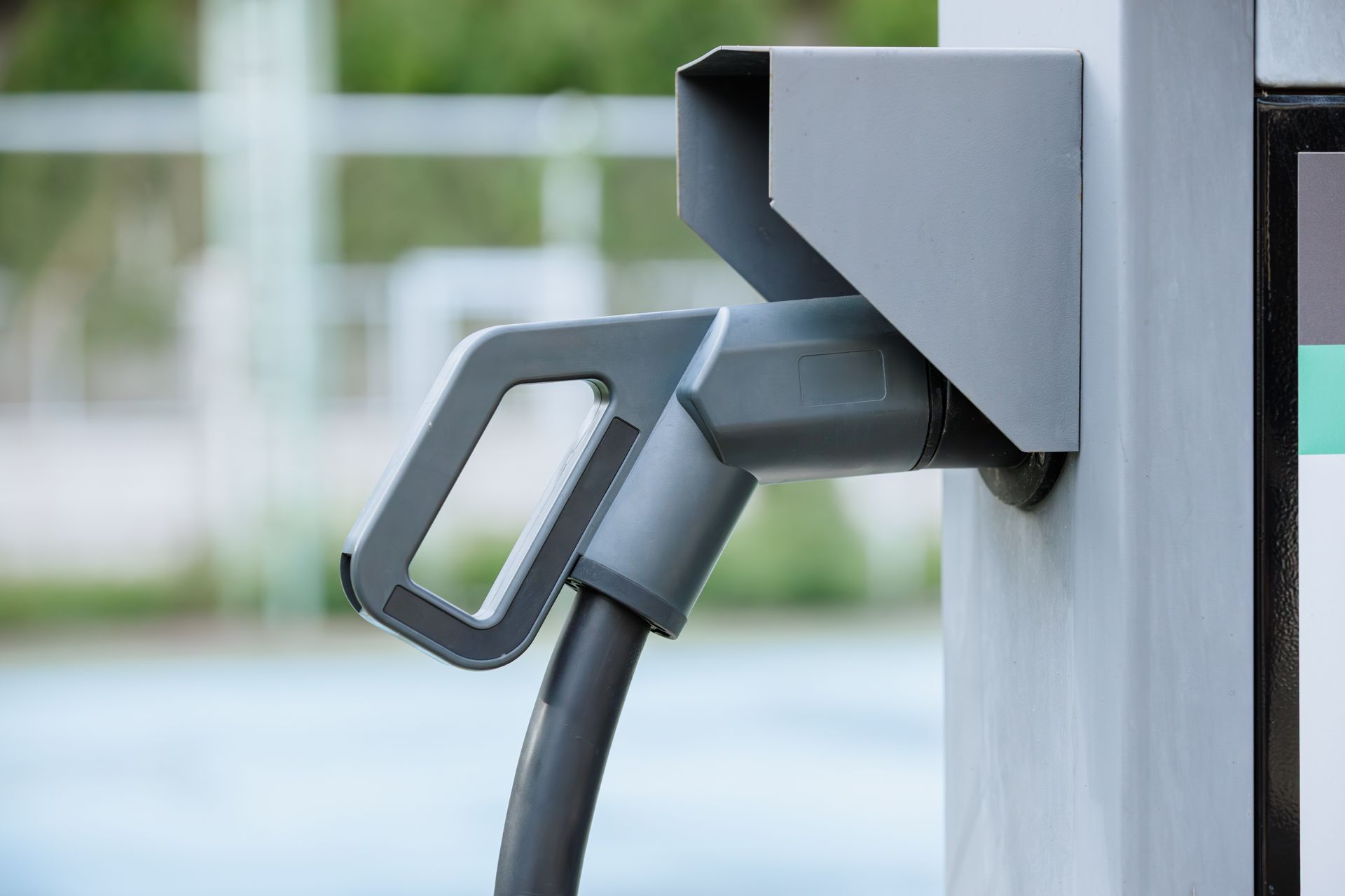 Electric vehicle charging plug connected to a charging station.