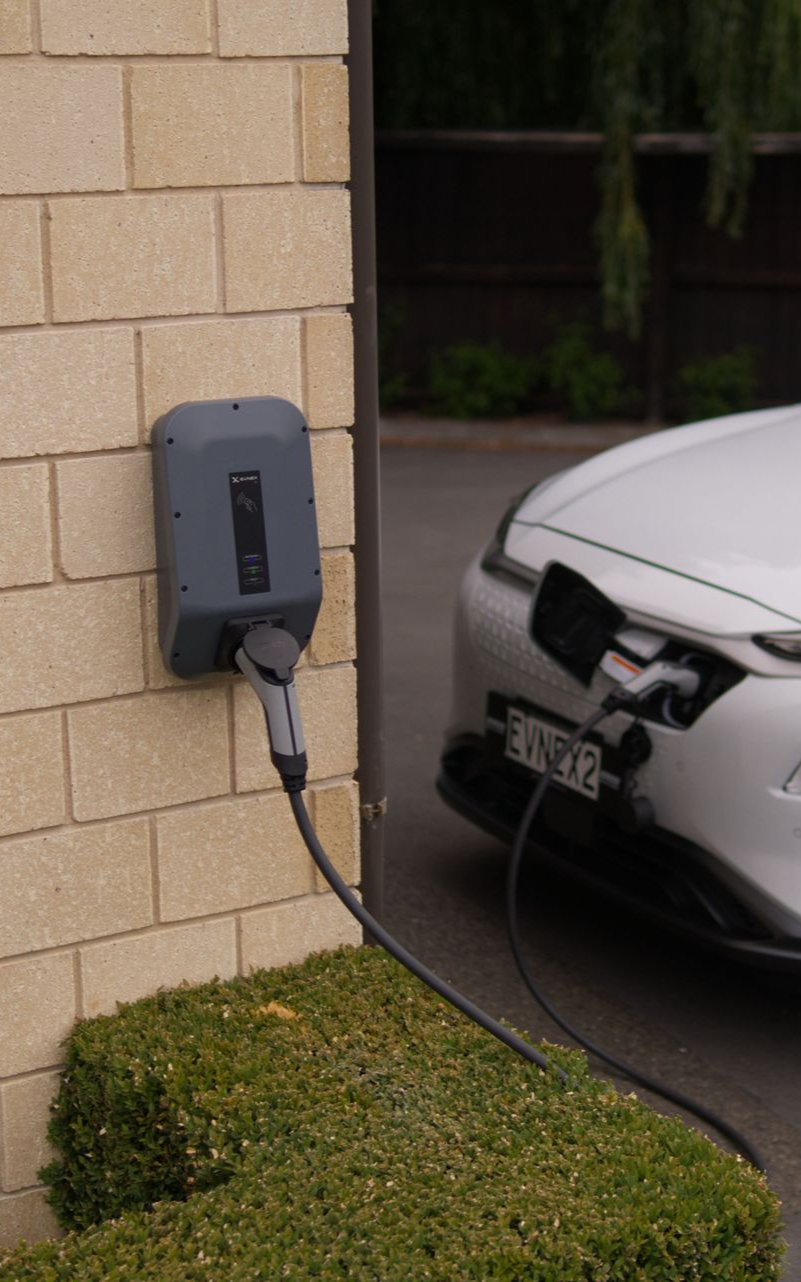 Electric vehicle charging plug connected to a charging station.