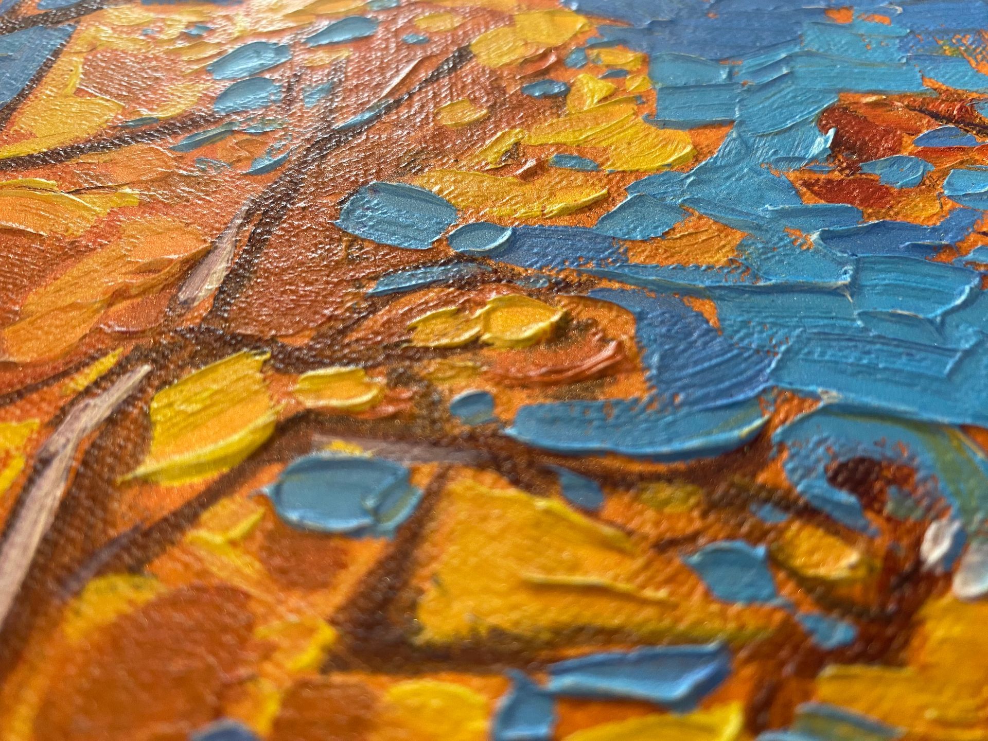 Raking light across raised brushwork texture