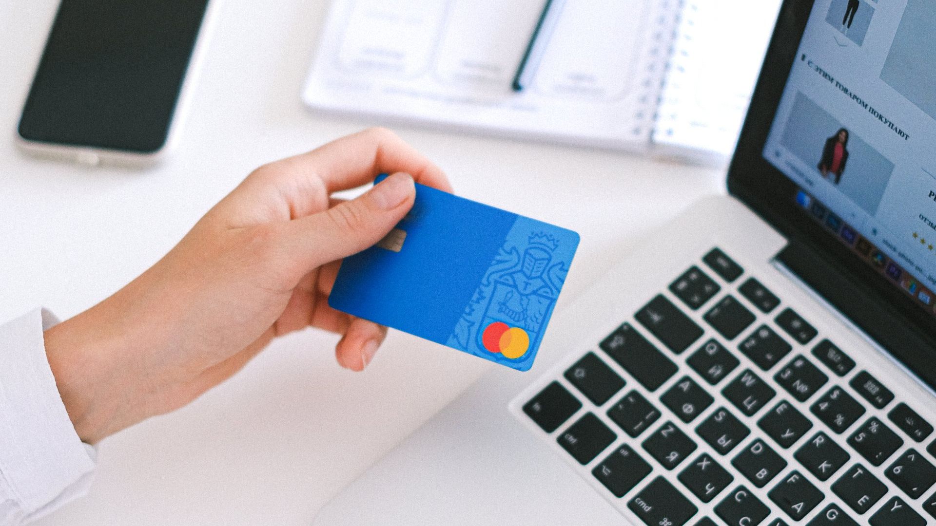 Holding a credit card in front of laptop