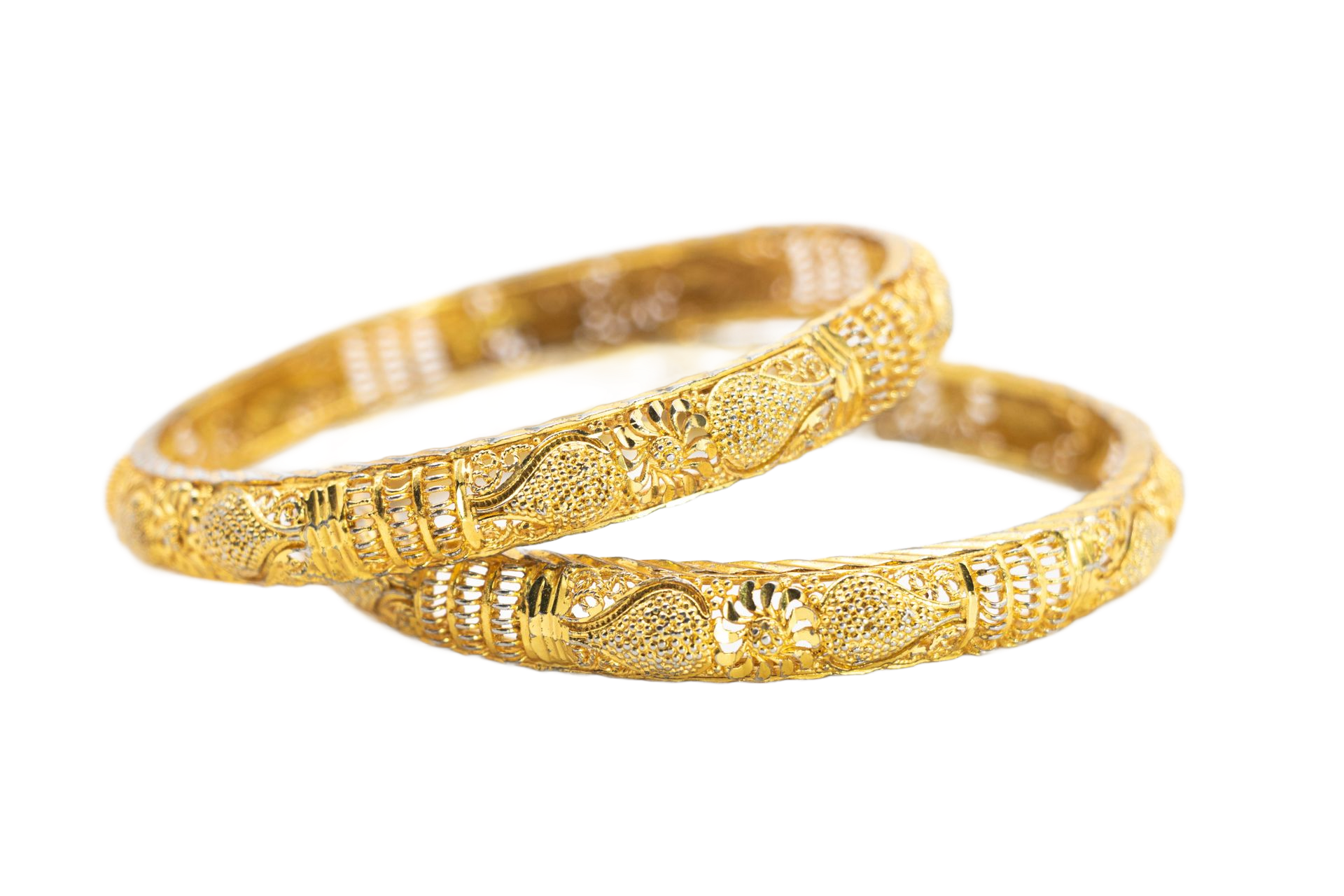 Two ornate gold bangles intertwined on a white background