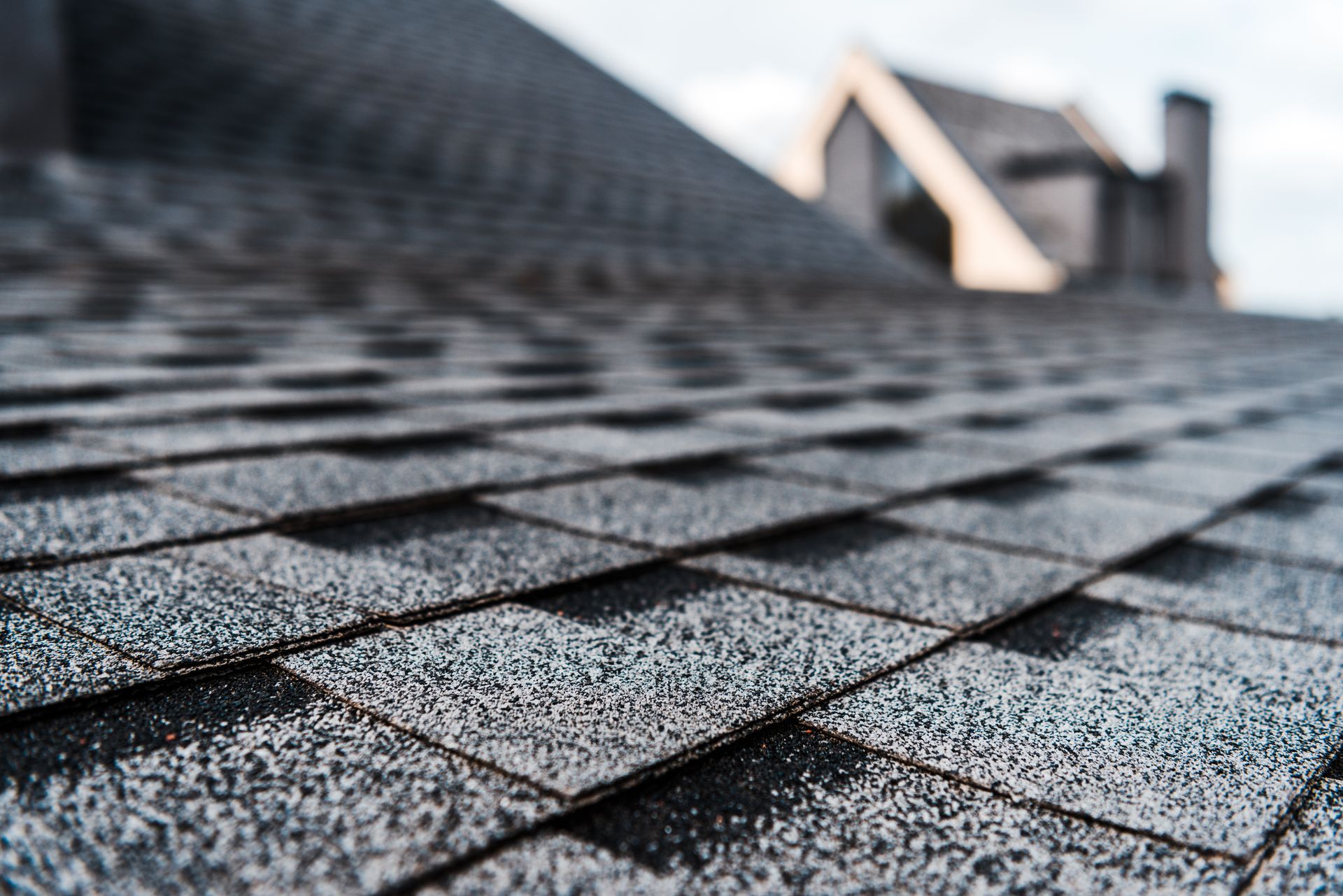 Close-up view of a dark gray asphalt shingle roof.