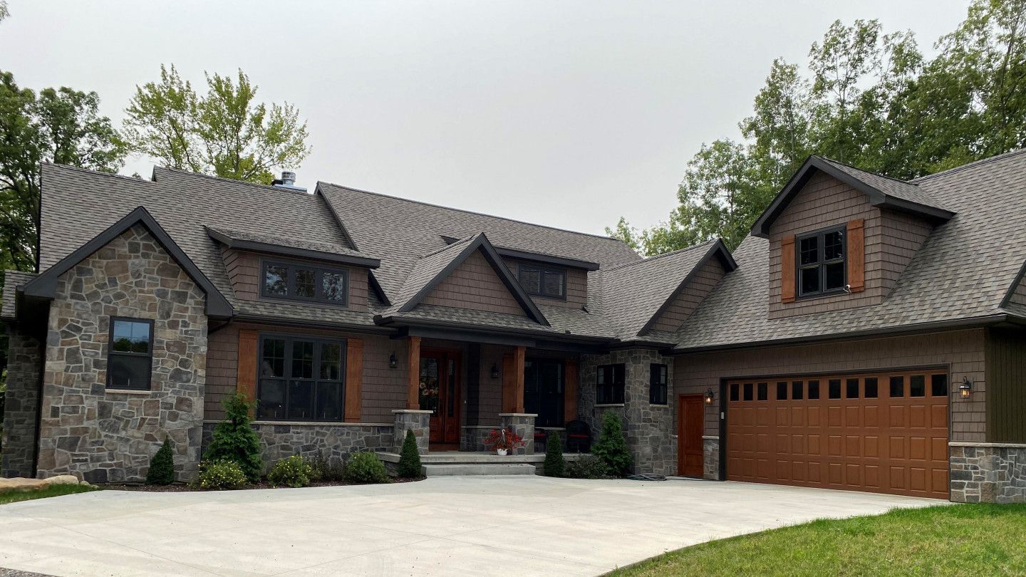 A large house with a garage and a driveway in front of it.