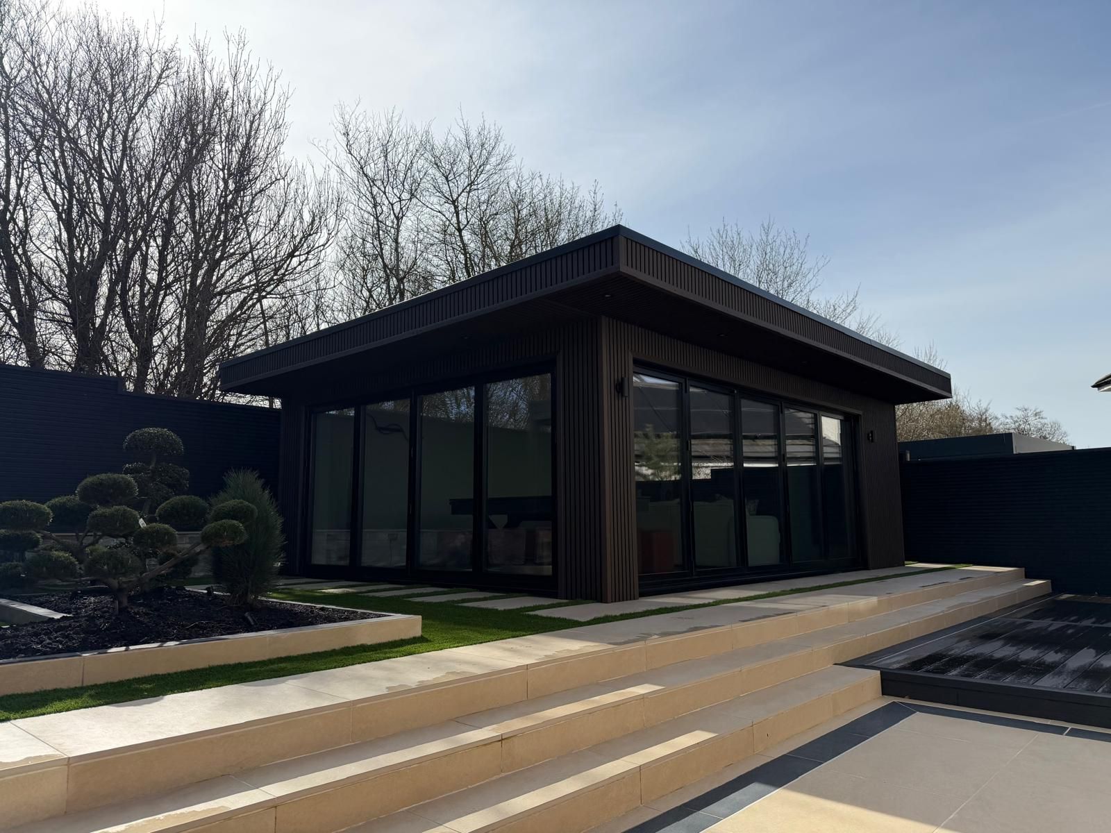 Bespoke garden room with hard landscaping in Glasgow by Oakspan Garden Rooms