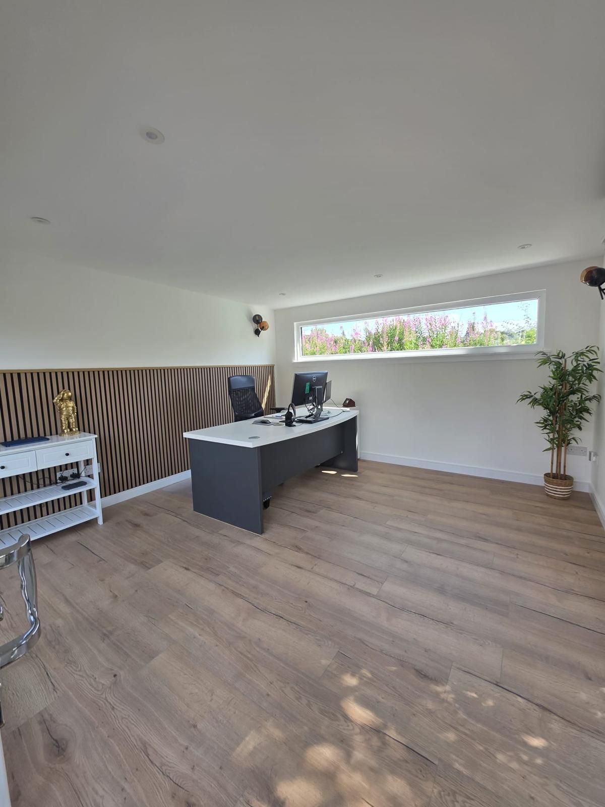 Completed Oakspan garden office interior with desk and acoustic glazing in Newton Mearns