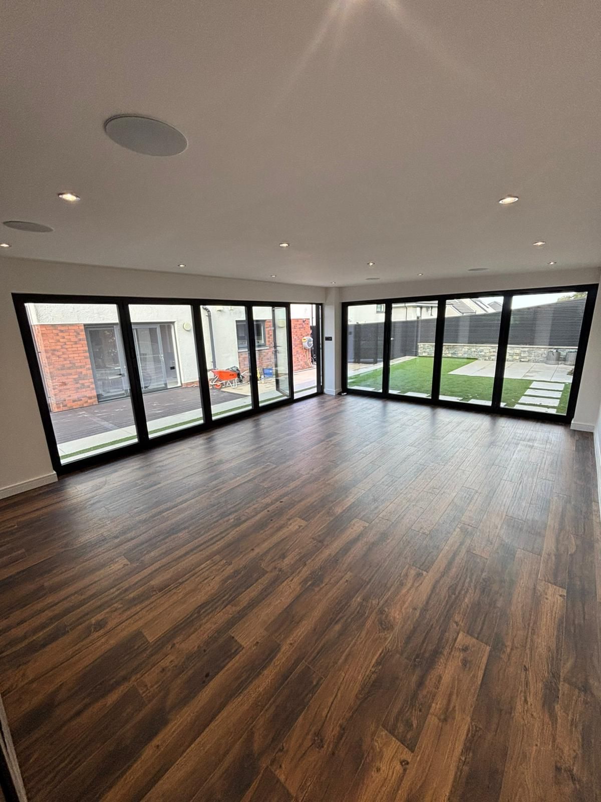 Interior of luxury garden room with built-in bar area, finished walls, ambient lighting, and integrated toilet space