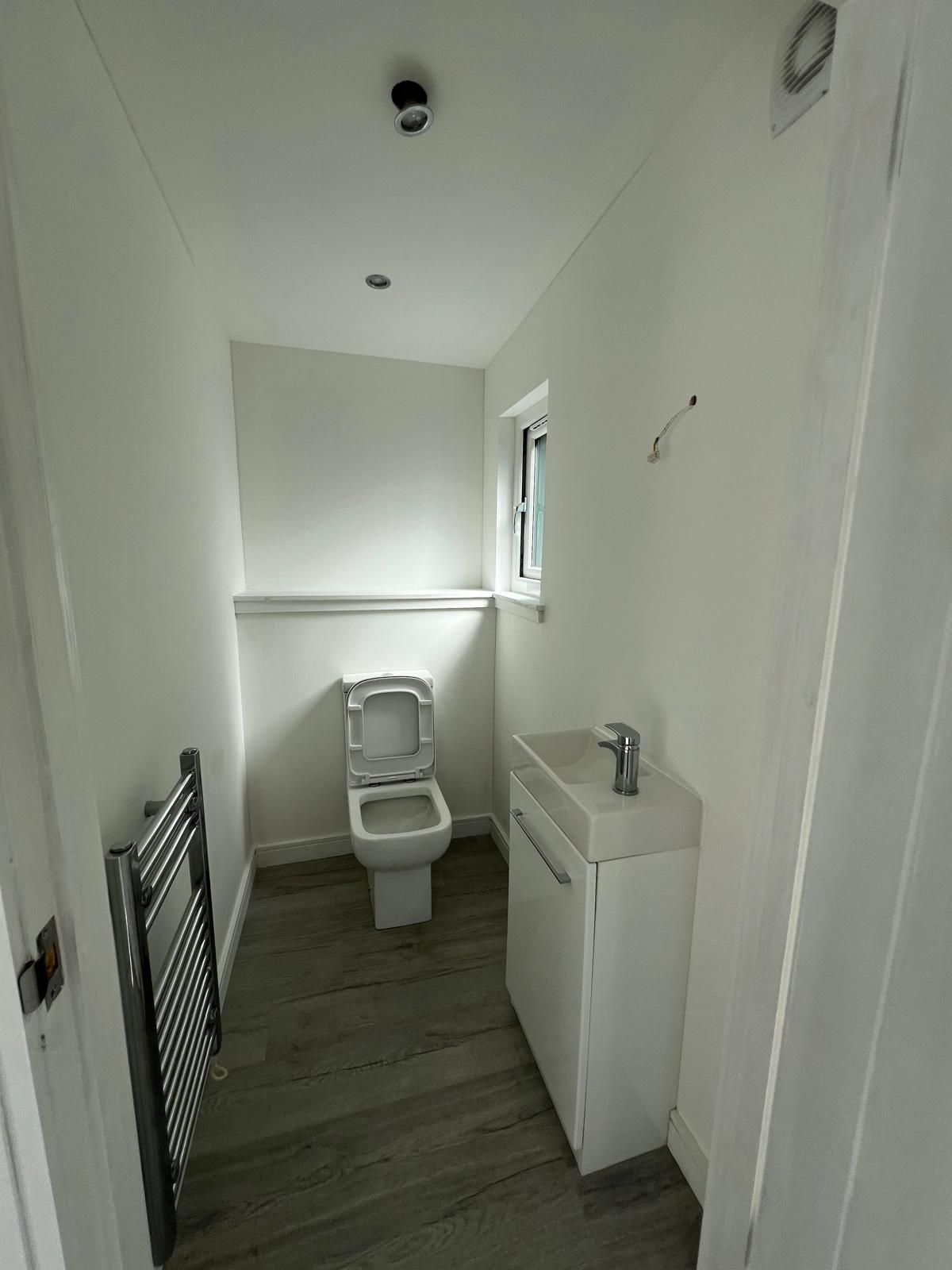 Composting toilet and self-contained wash basin inside a Bearsden garden room