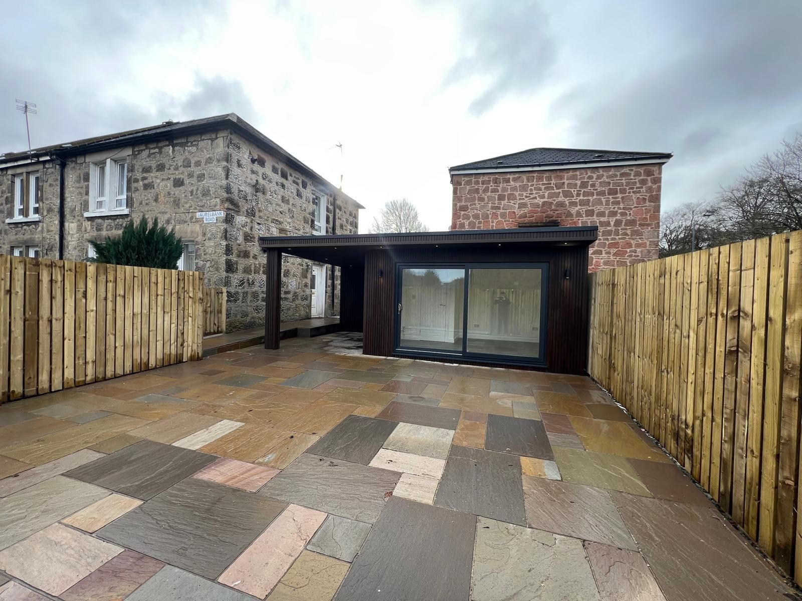 Completed compact Oakspan garden room mini annexe with covered canopy in Chryston North Lanarkshire