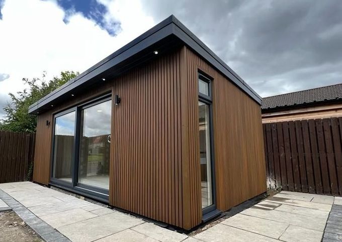 a small wooden building with sliding glass doors
