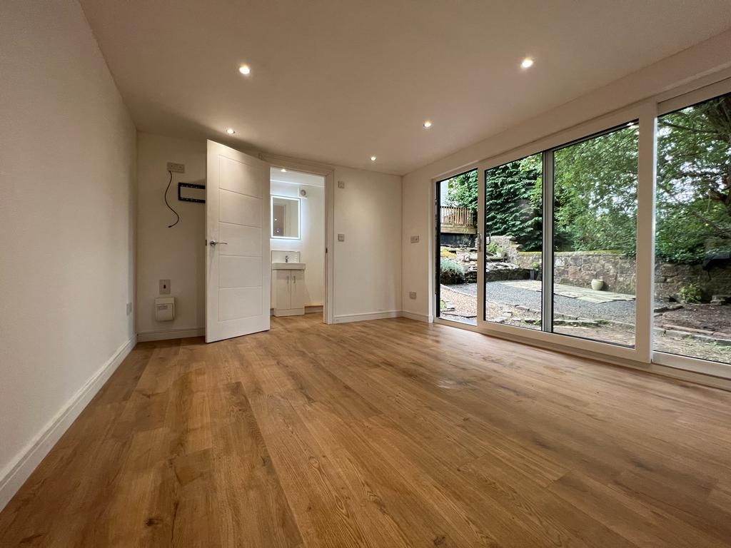 A garden office pod with spacious interior looking out to garden permission and building regulations, ensuring a safe and legal space.