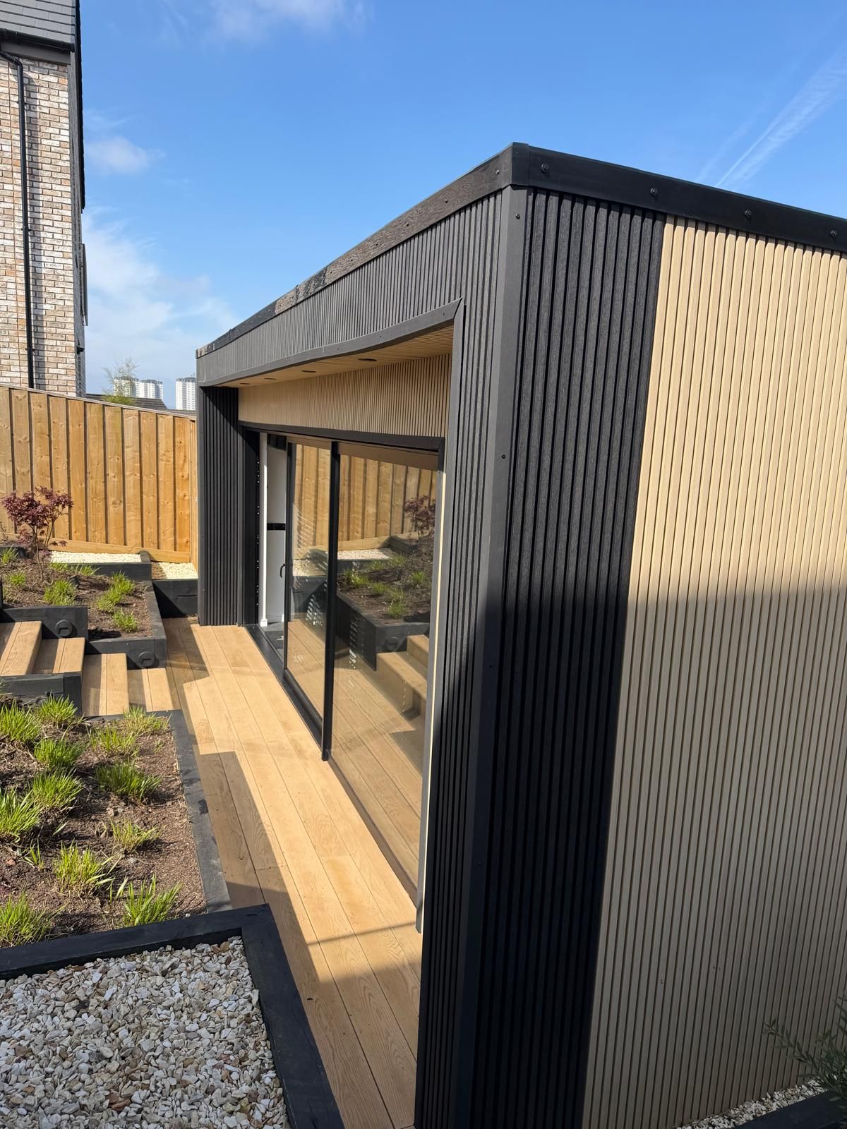 Aluminium glazing composite decking and landscaped steps beside an Oakspan garden room in Jordanhill Glasgow