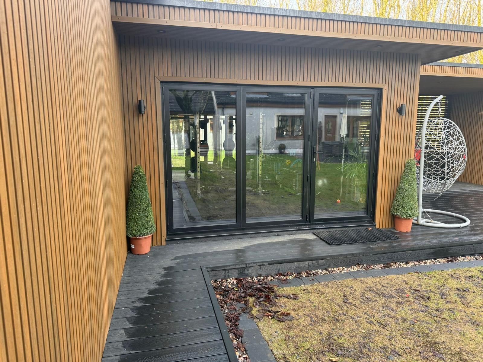 Close-up of composite cladding and aluminium bifold doors on the Oakspan garden room in Kilmarnock