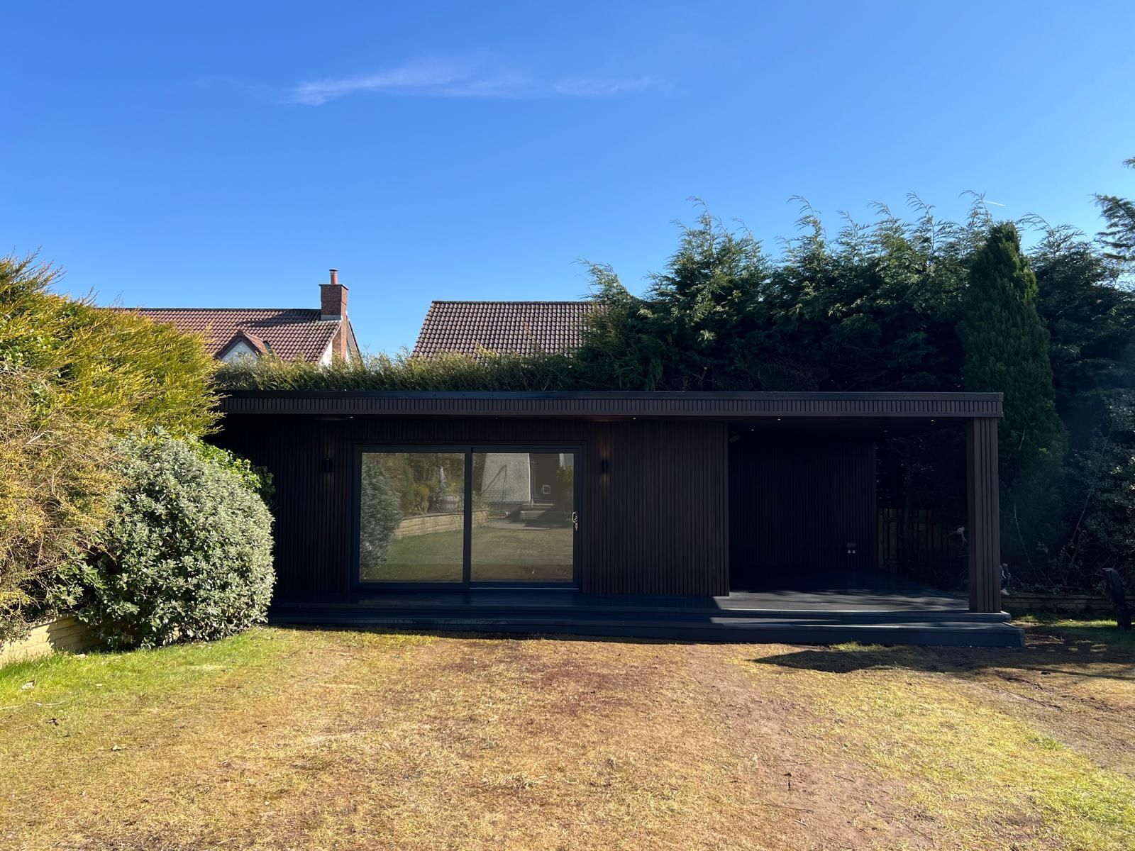 Completed 6 metre by 4 metre Oakspan garden room with covered canopy in Newton Mearns