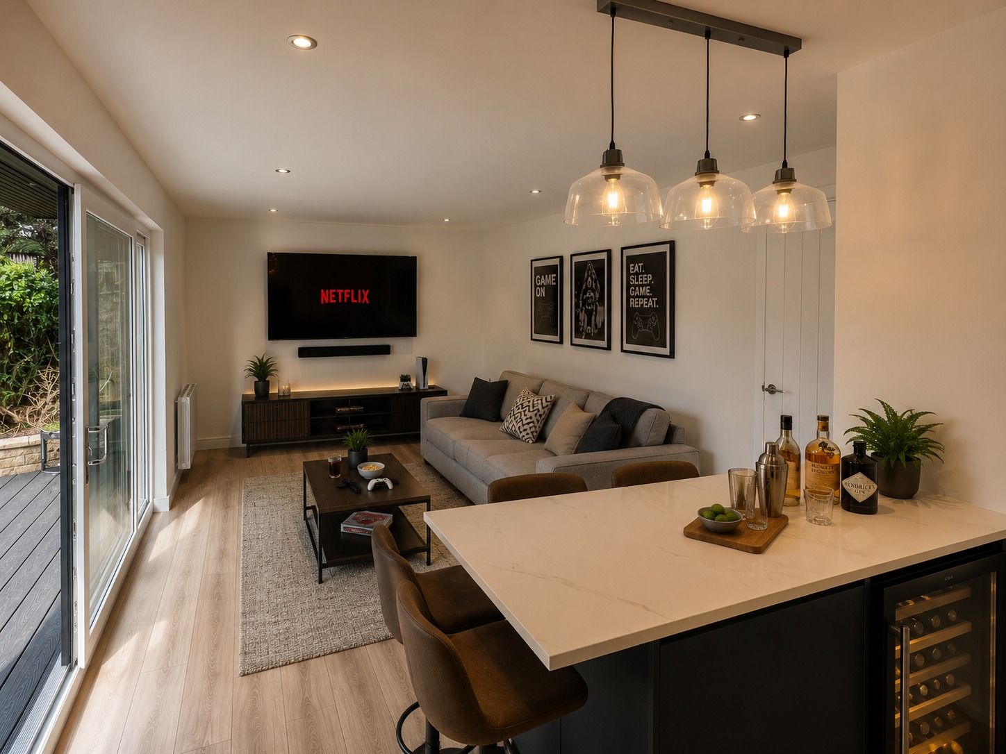Lifestyle visualisation of a furnished Oakspan garden room with lounge gaming area and fitted bar