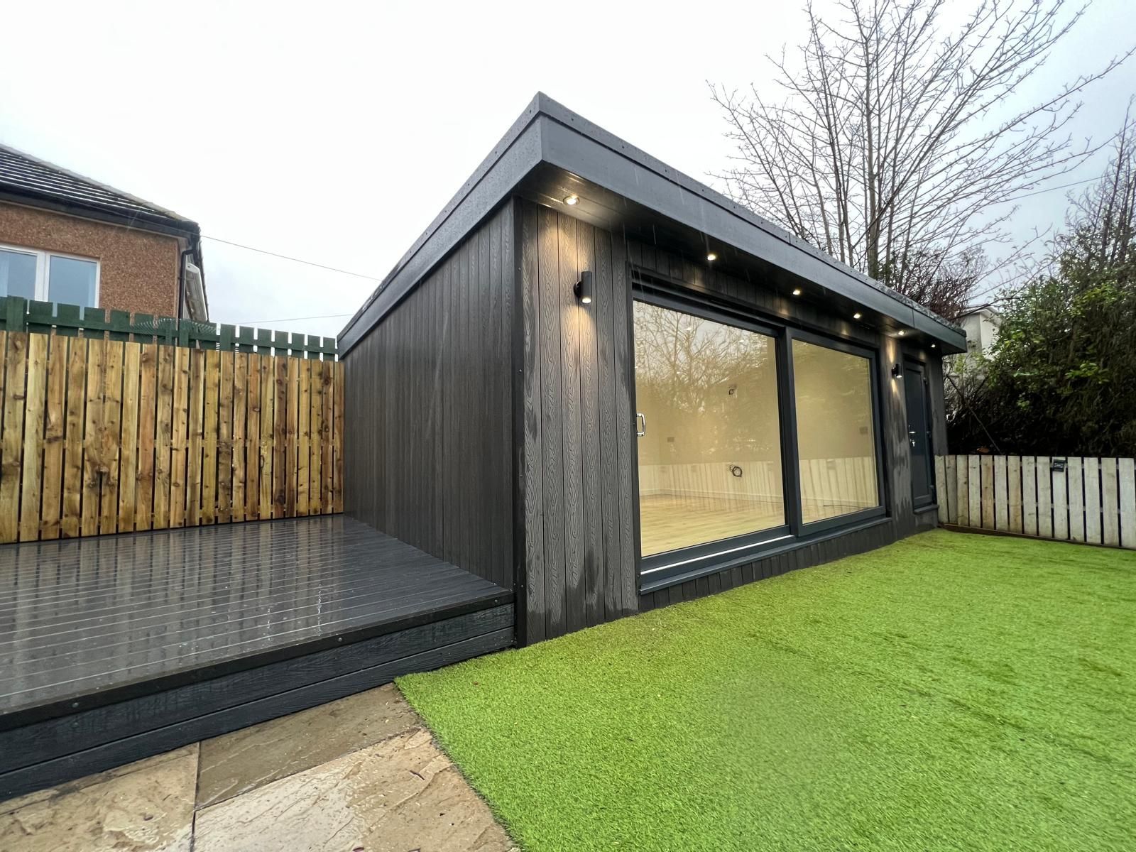 Black composite Oakspan garden office with a finished deck