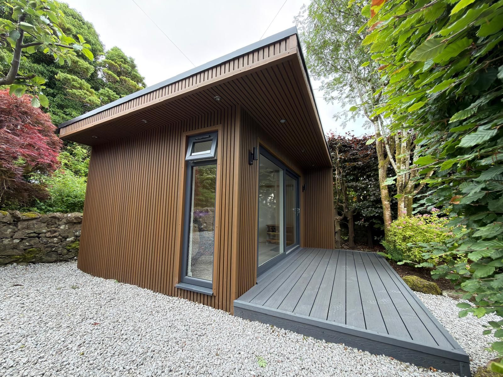 Oakspan Composite Cladding And Deck Finished Oakspan garden room with contemporary composite cladding and matching deck