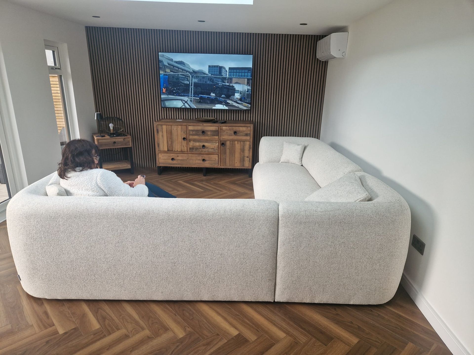 Oakspan Finished Garden Room Interior With Slatted Wall Finished Oakspan living room with slatted feature wall, lighting and climate control