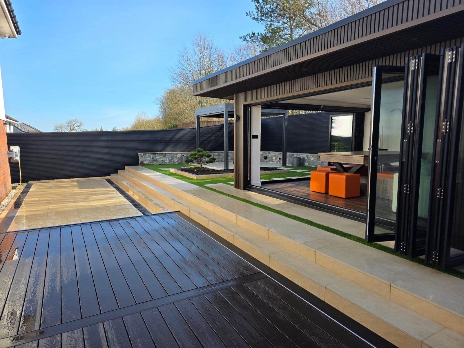 Oakspan Six Metre Aluminium Bifold Doors Six-metre aluminium bifold doors opening an Oakspan garden room onto a landscaped garden