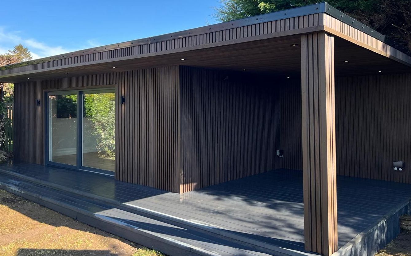 Large garden room in Newton Mearns with 10m x 5m covered entertainment space, featuring a stylish bar and private toilet, designed for outdoor living.