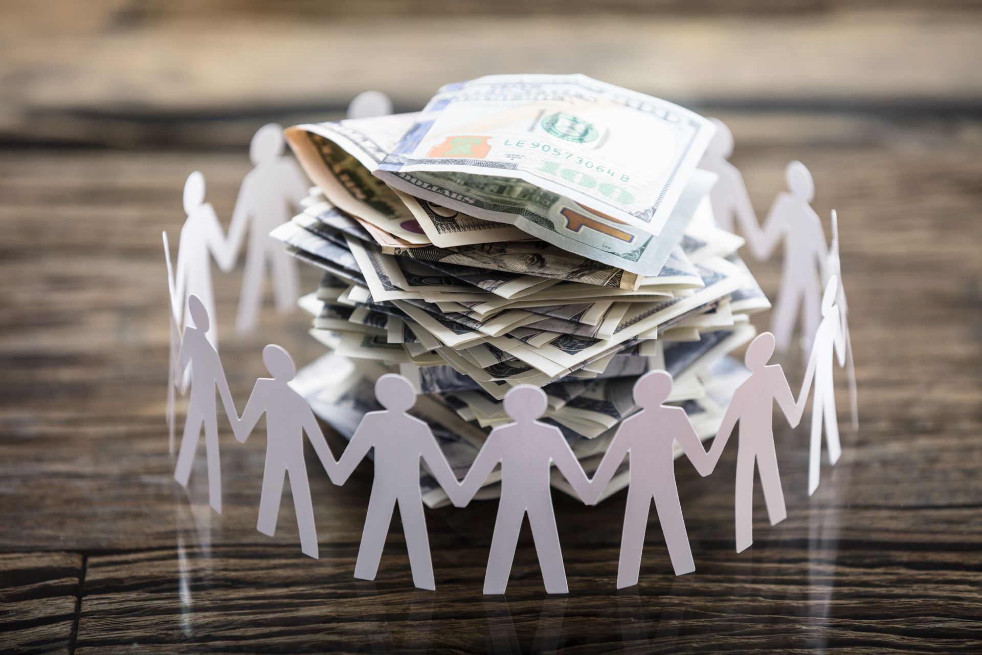 Community members surrounding donated money for financial assistance. Community members surrounding donated money for financial assistance.