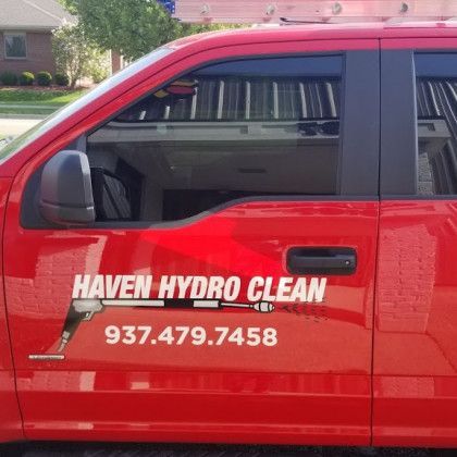 Red Haven Hydro Clean truck with company logo and phone number.