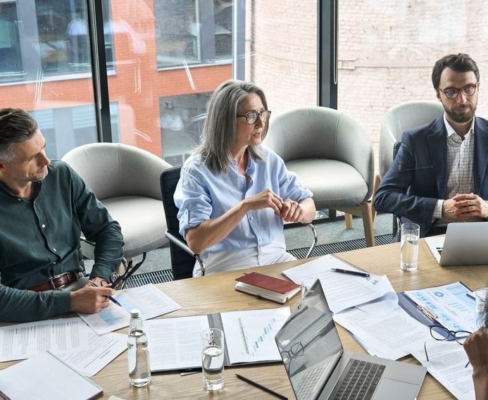 3 people sitting at a table talking about if they should choose ROSE to be their US subsidiary accounting service for their foreign entities