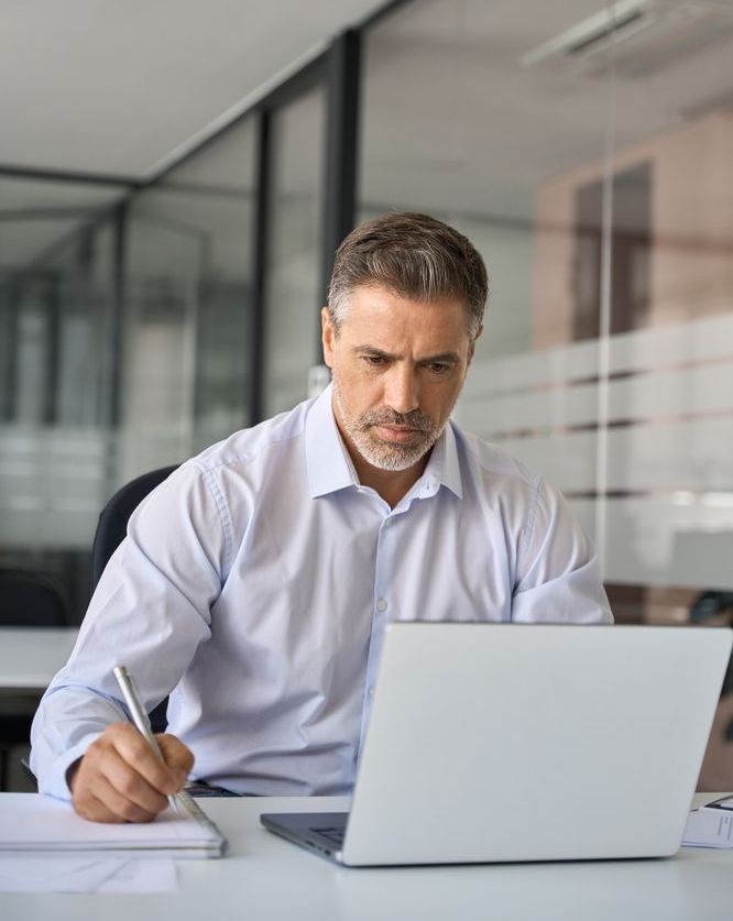 a CFO works on his laptop in the office