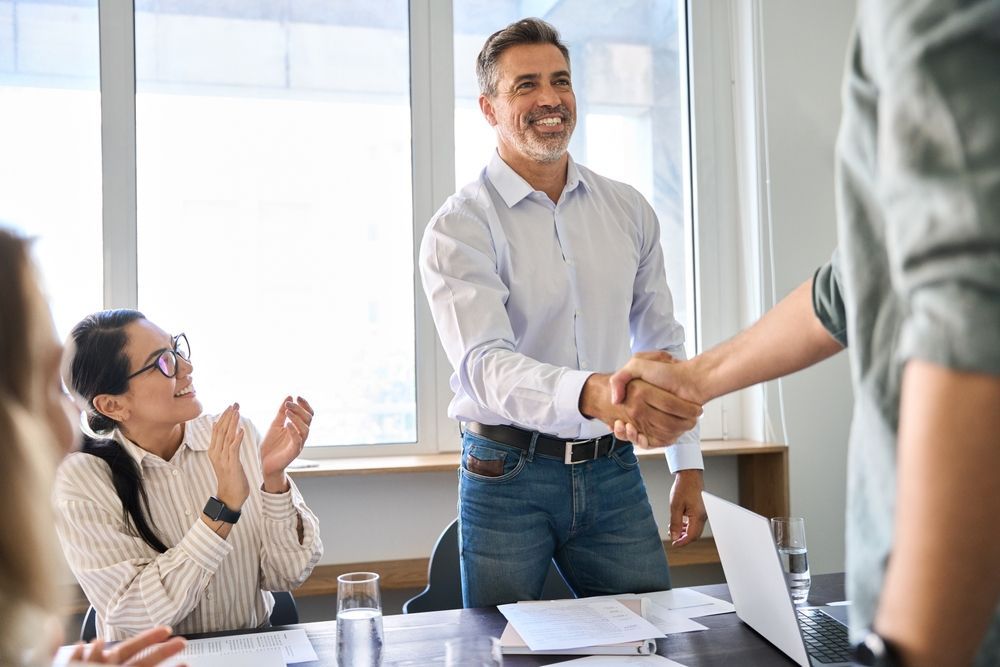 the CFO shakes hands with another man