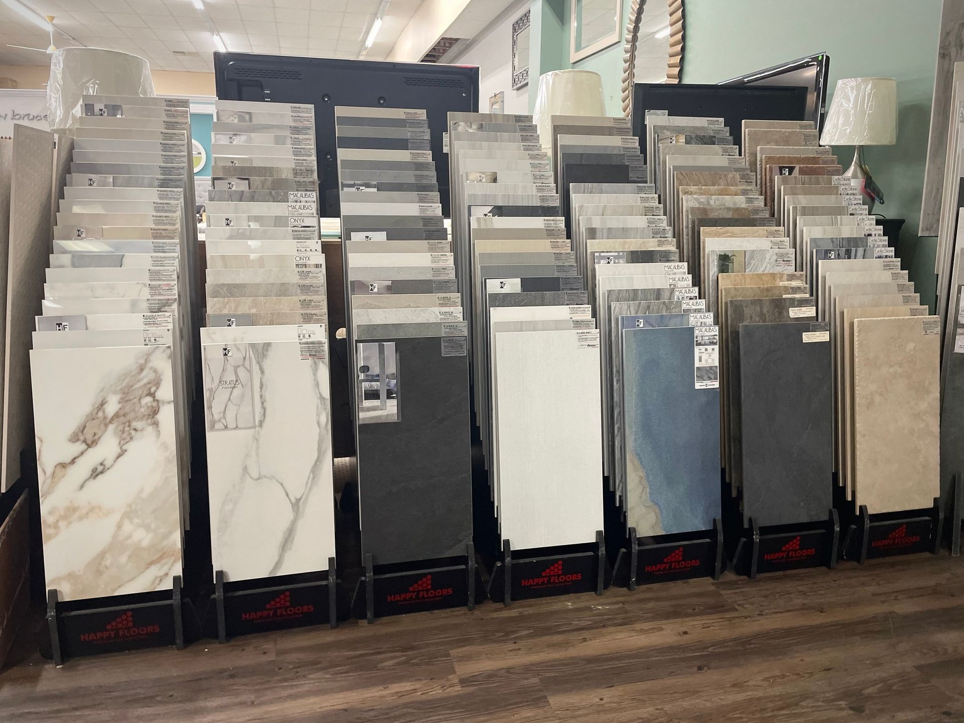 Rows of tile and flooring samples displayed in a showroom aisle