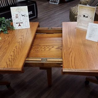 Wooden restaurant booth table split in the middle with a hidden center extension tray.
