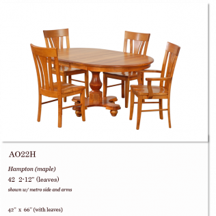 Oak dining table set with four matching wooden chairs and leaf extensions