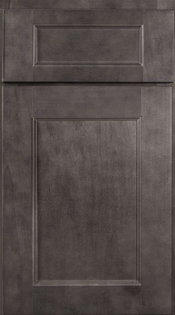 Gray wood-paneled cabinet door with a small upper drawer and a large lower panel.