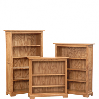 Three wooden bookshelves in a studio shot, two tall and one short, arranged side by side.